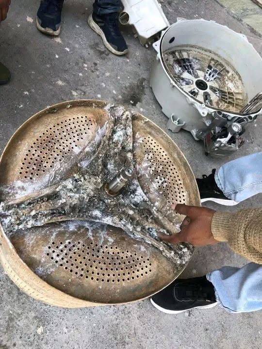 Heavily scaled washing machine drum before deep cleaning